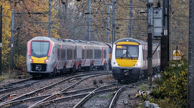 Brand new Greater Anglia Stadler bi-mode train next to one of the trains it will be replacing