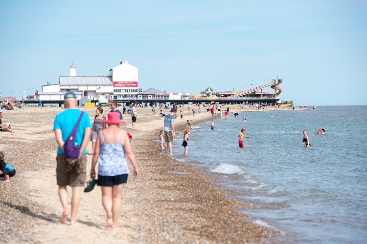view of great yarmouth pier and people on beach