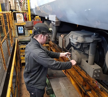 Jack Blake, Technician at Ilford Depot fitting an axle box cover.