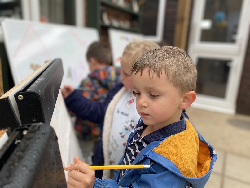 Child, using the easel for drawing 