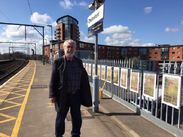 Artist, Wladyslaw Mirecki, with the paintings at Chelmsford station