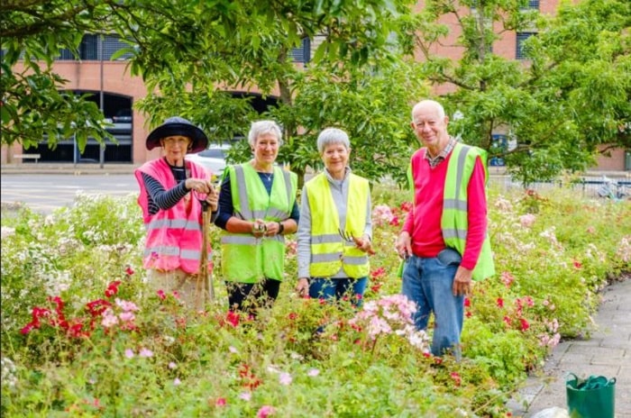 Norwich station adopters in flower bed