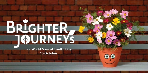 Campaing poster shows a flowery pot with a smiley face drawn on it, on top of a station bench