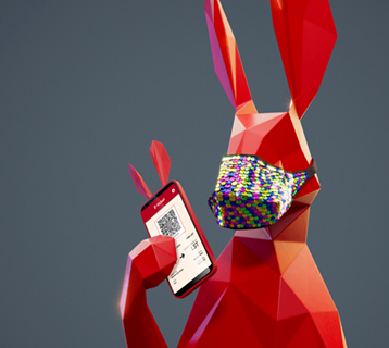 Red hare with colourful sequined face covering holding a phone
