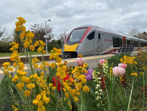 Greater Anglia new train near Cantley station platform flowers