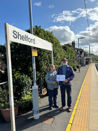 Kathryn and Philip Ball with their accreditation certificate at Shelford station