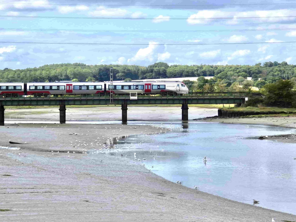 Greater Anglia train travelling over a bridge 