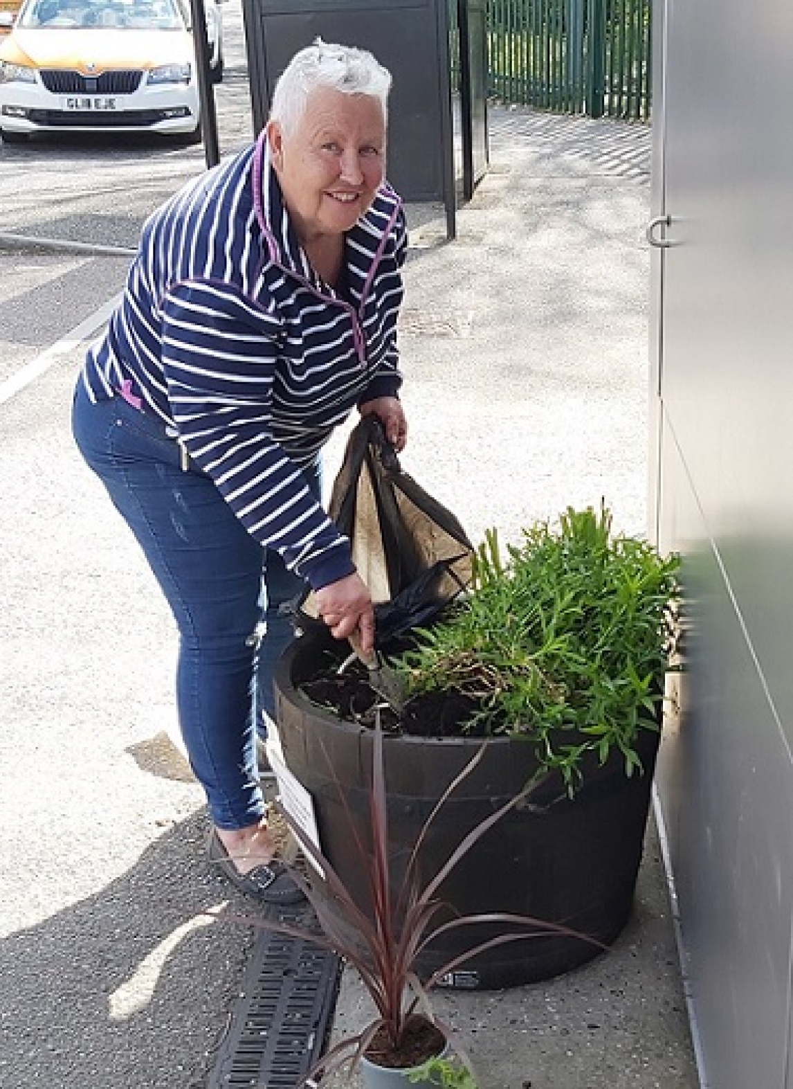 Forget Me Not Cafe volunteer, Maureen Jackson-Webb, planting flowers at Billericay station.