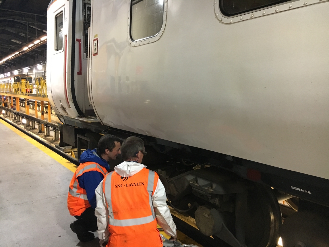 Engineers inspecting train wheels