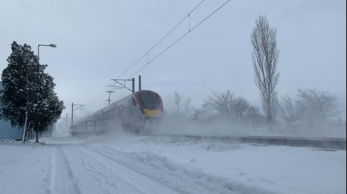 Greater anglia train going through the snow 