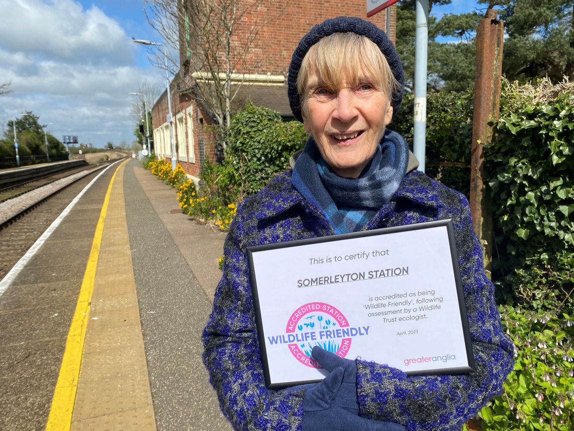 Somerleyton station adopter, Sue Cox, receives the accreditation on behalf of the team of station adopters. 
