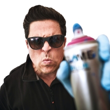 Dom Joly with a spray paint can