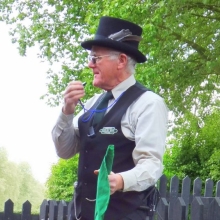 A man in a top hat with a whistle
